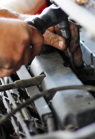 Hand of auto mechanic with a wrench